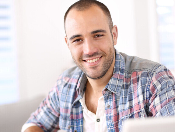 Man working on laptop computer from home Man working on laptop computer from home